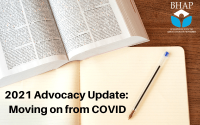 a desk with a legal book open and a notebook underneath it, with a pen on the notebook. Text reads, '2021 Advocacy Update: Moving on from COVID'