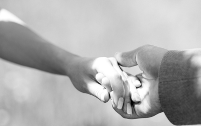 Grayscale photo of 2 person holding hands